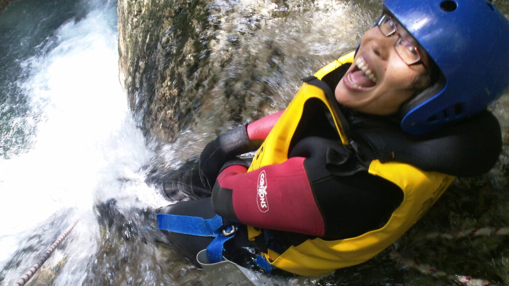 Courageous Emi atop the 65 foot waterfall drop