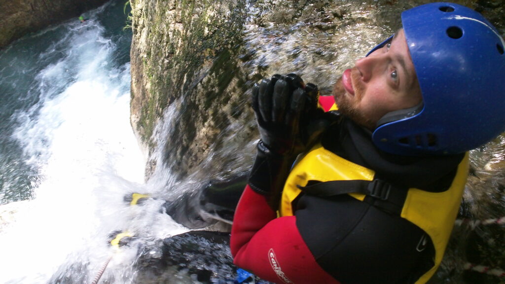 Logan considers eternity before the 65-foot waterfall side